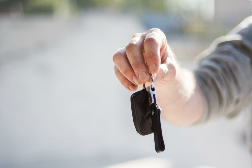 A hand holding keys to a vehicle