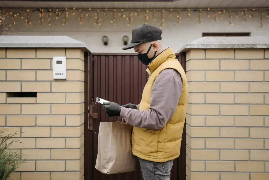 A delivery man holding a package