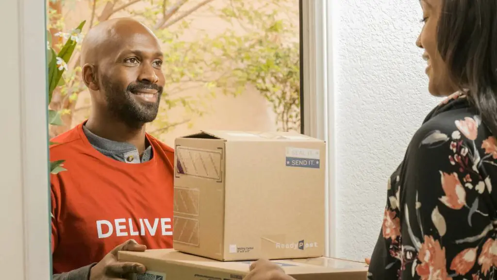 A delivery man delivering a box to a customer