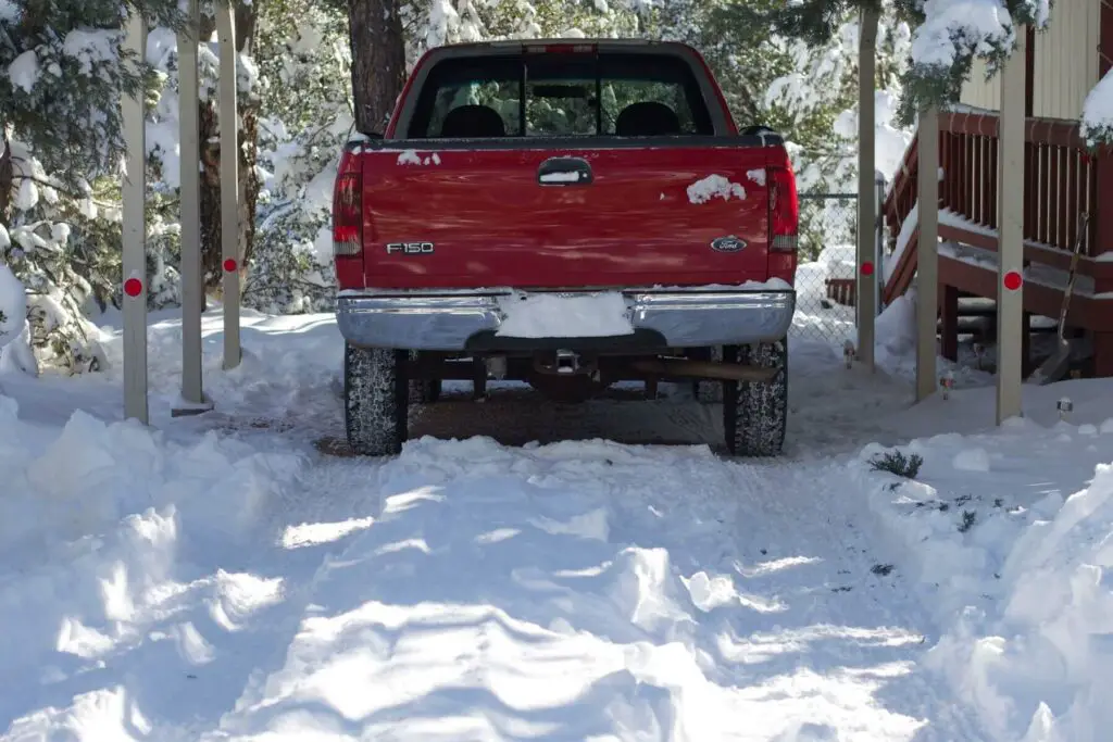 Parked truck in a snow-covered driveway