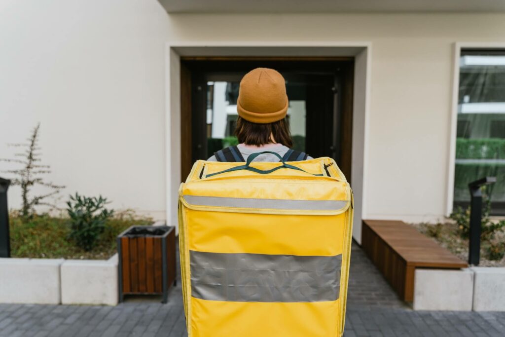  A delivery man standing in front of a house
