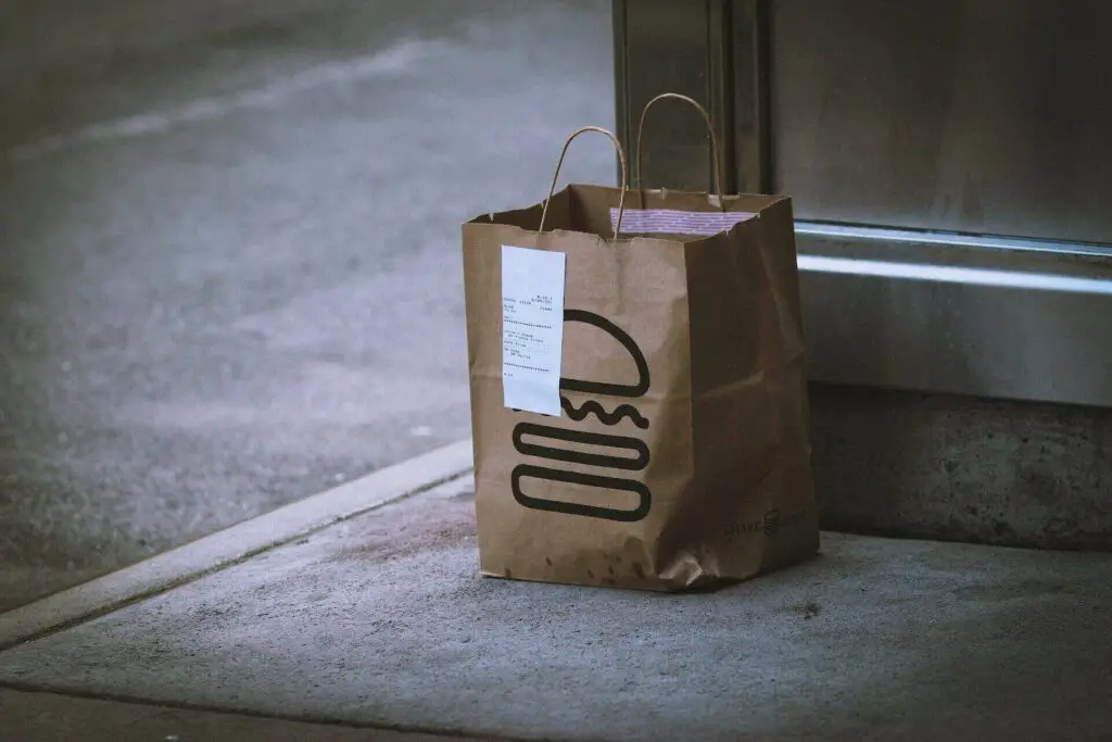 A bag with take-out food on the ground